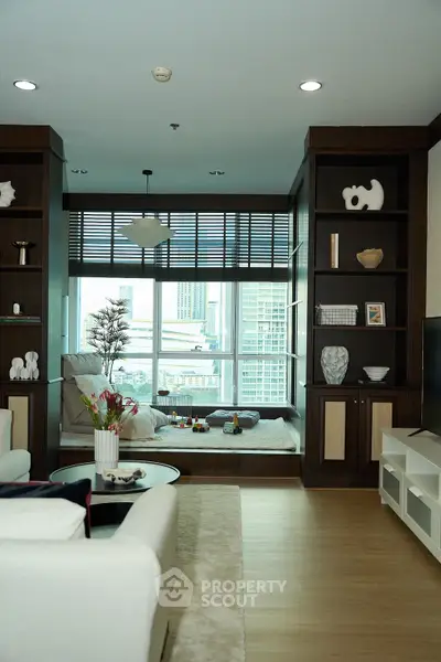 Luxurious living room with city view, elegant decor, and cozy seating area, perfect for relaxation and entertainment.
