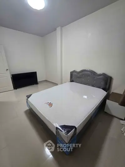 Spacious bedroom with new mattress and modern headboard in minimalist design