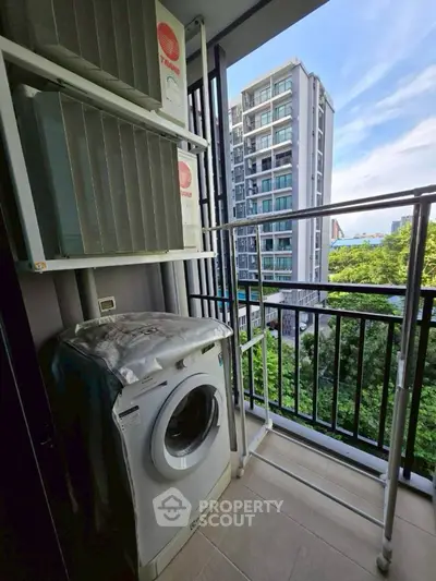 Modern apartment balcony with washing machine and scenic city view