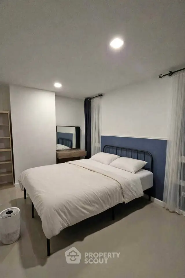 Modern bedroom with minimalist design and cozy ambiance, featuring a comfortable bed and stylish decor.