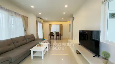 Spacious modern living room with sleek furniture and ample natural light
