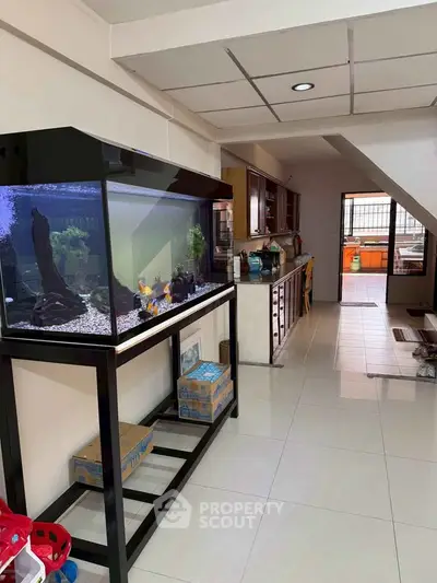 Spacious kitchen with large aquarium and modern cabinetry