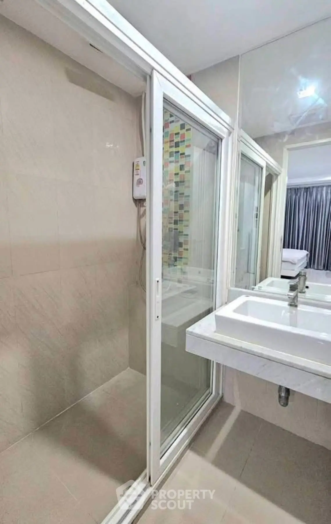 Modern bathroom with glass shower enclosure and sleek sink design