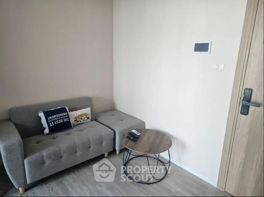 Cozy living room with modern gray sofa and stylish round coffee table.