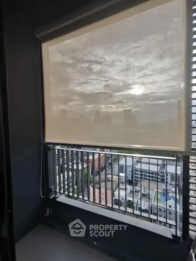 Modern balcony with city view and sunshade in high-rise apartment