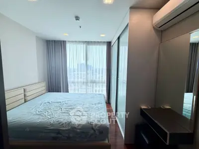 Modern bedroom with large window and stylish decor in a high-rise apartment.