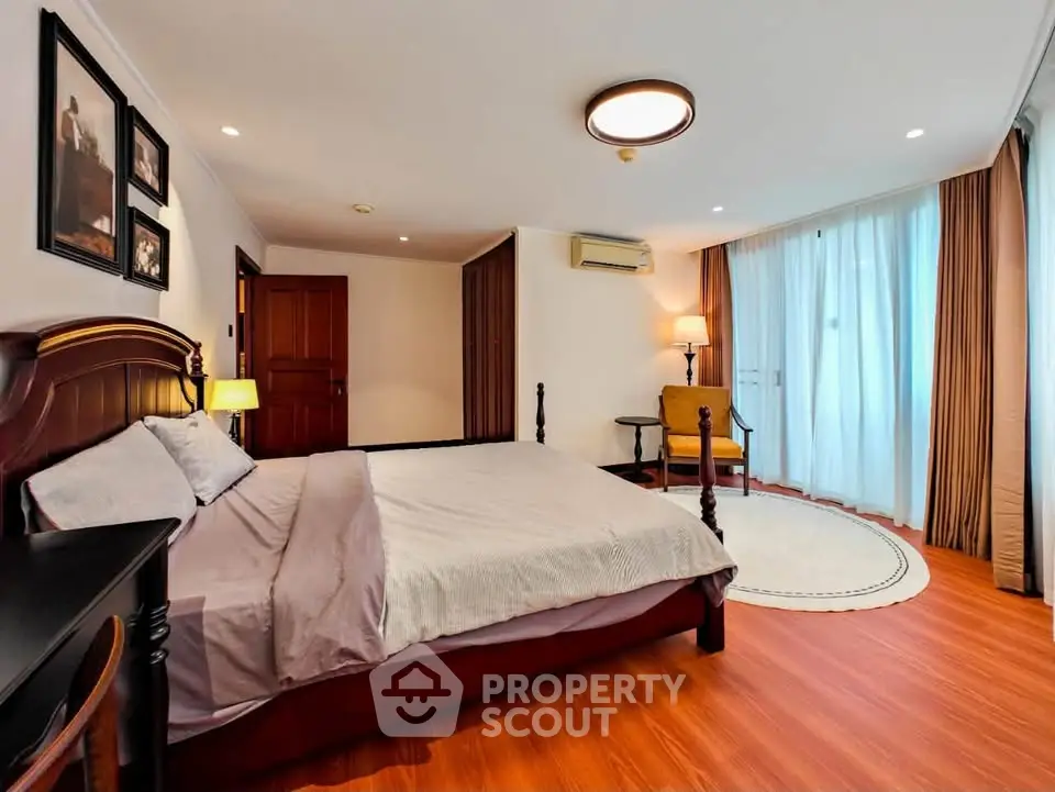 Spacious bedroom with elegant decor and natural light