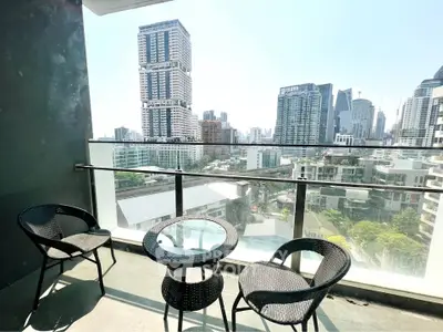Stunning city view from modern balcony with stylish outdoor seating