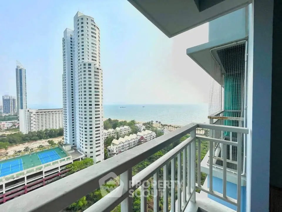 Stunning ocean view from high-rise balcony with modern cityscape.