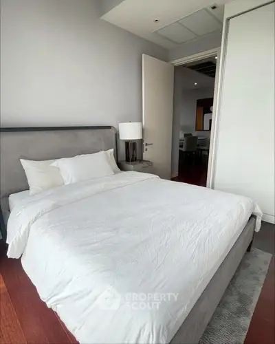 Modern bedroom with cozy bed and elegant decor in a stylish apartment.