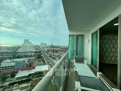 Stunning city view from a modern high-rise balcony with sleek glass railing.