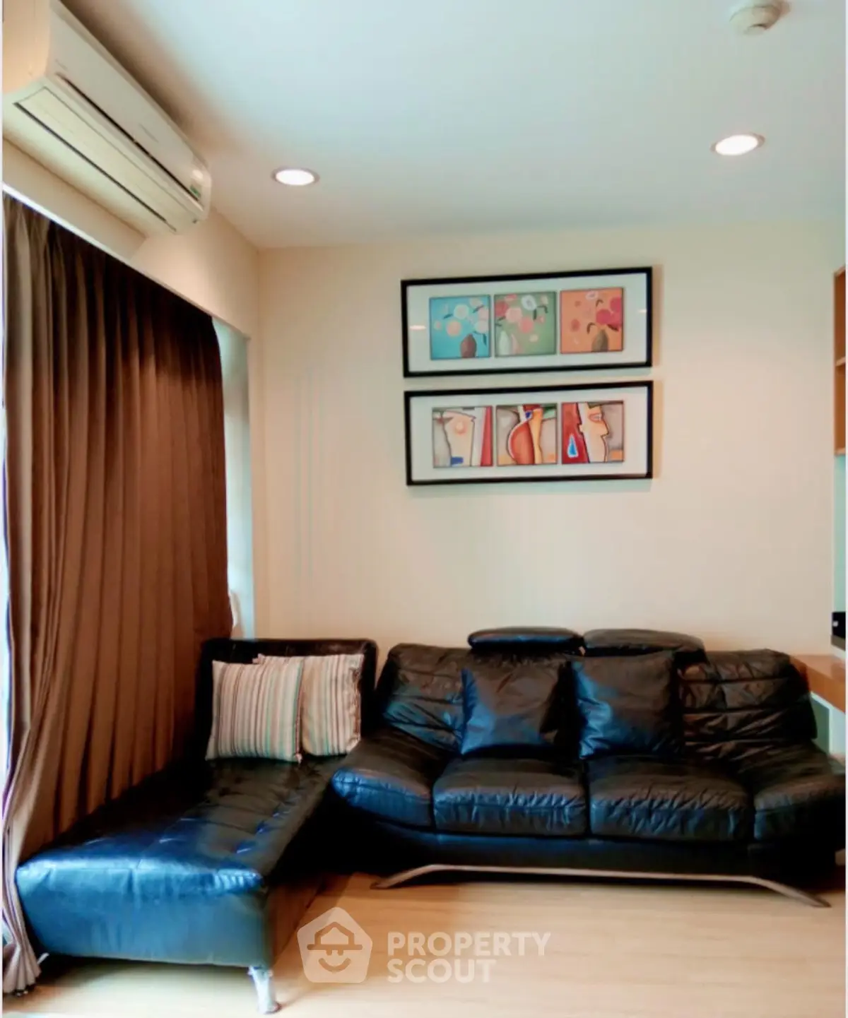 Stylish living room with leather sofa and modern art, perfect for relaxation and entertaining.