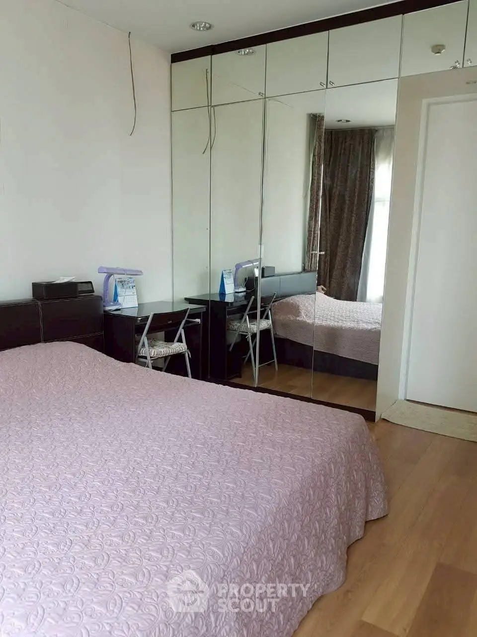 Cozy bedroom with mirrored wardrobe and elegant decor