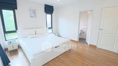 Spacious bedroom with ensuite bathroom and modern decor