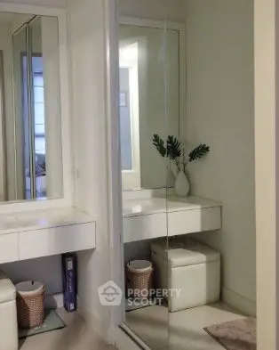 Elegant dressing area with mirror and modern decor in a stylish home interior.