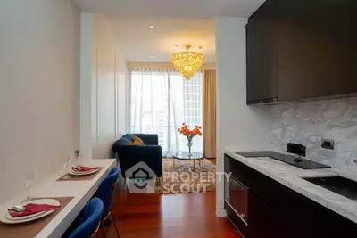 Luxurious open-plan kitchen and living room with elegant chandelier and city view.