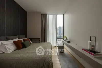 Modern bedroom with city view, featuring elegant decor and large window.