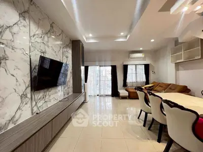 Elegant living room with marble accent wall and modern furniture