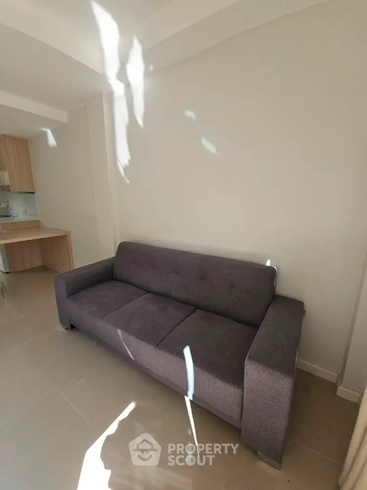 Modern living room with sleek gray sofa and minimalist design