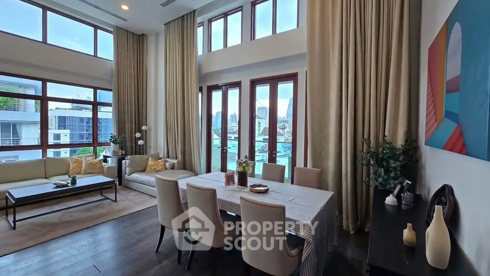 Luxurious living room with high ceilings and elegant dining area