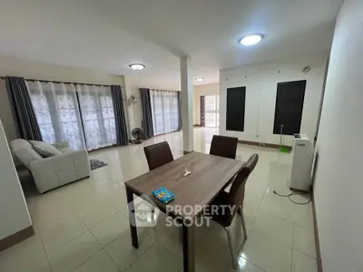 Spacious living room with modern furniture and large windows for natural light.