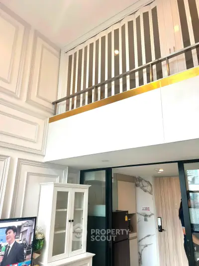 Modern loft apartment with stylish interior and high ceilings, featuring a sleek kitchen and elegant decor.
