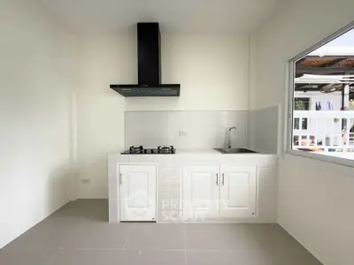 Modern kitchen with sleek gas stove and minimalist design, perfect for culinary enthusiasts.