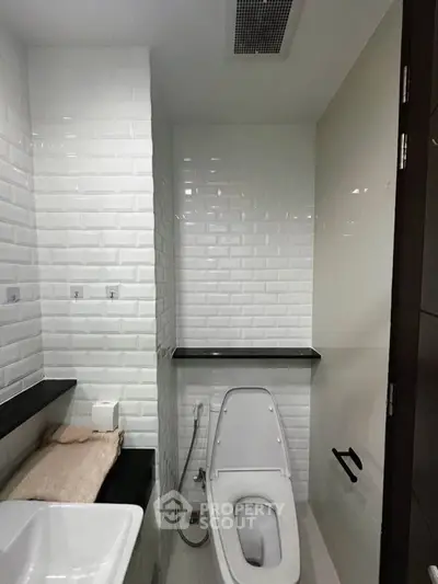 Modern bathroom with sleek white tiles and contemporary fixtures