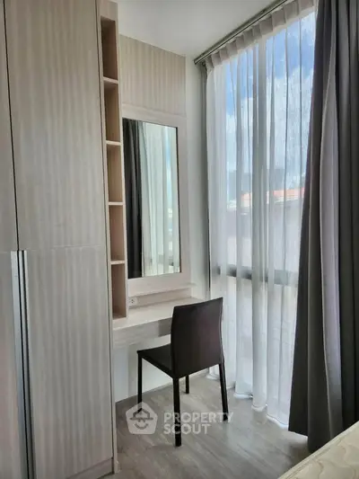 Bright study nook with modern desk and chair by large window in stylish apartment.
