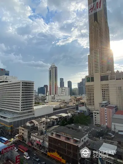 Stunning cityscape view with towering skyscrapers and vibrant urban landscape under a dramatic sky.