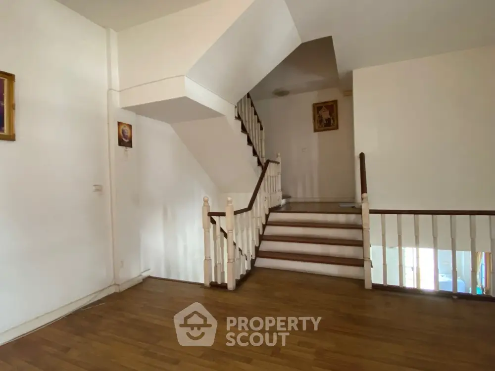 Spacious interior with elegant staircase and wooden flooring