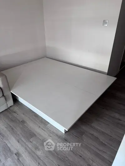 Modern minimalist interior with sleek platform bed and hardwood flooring