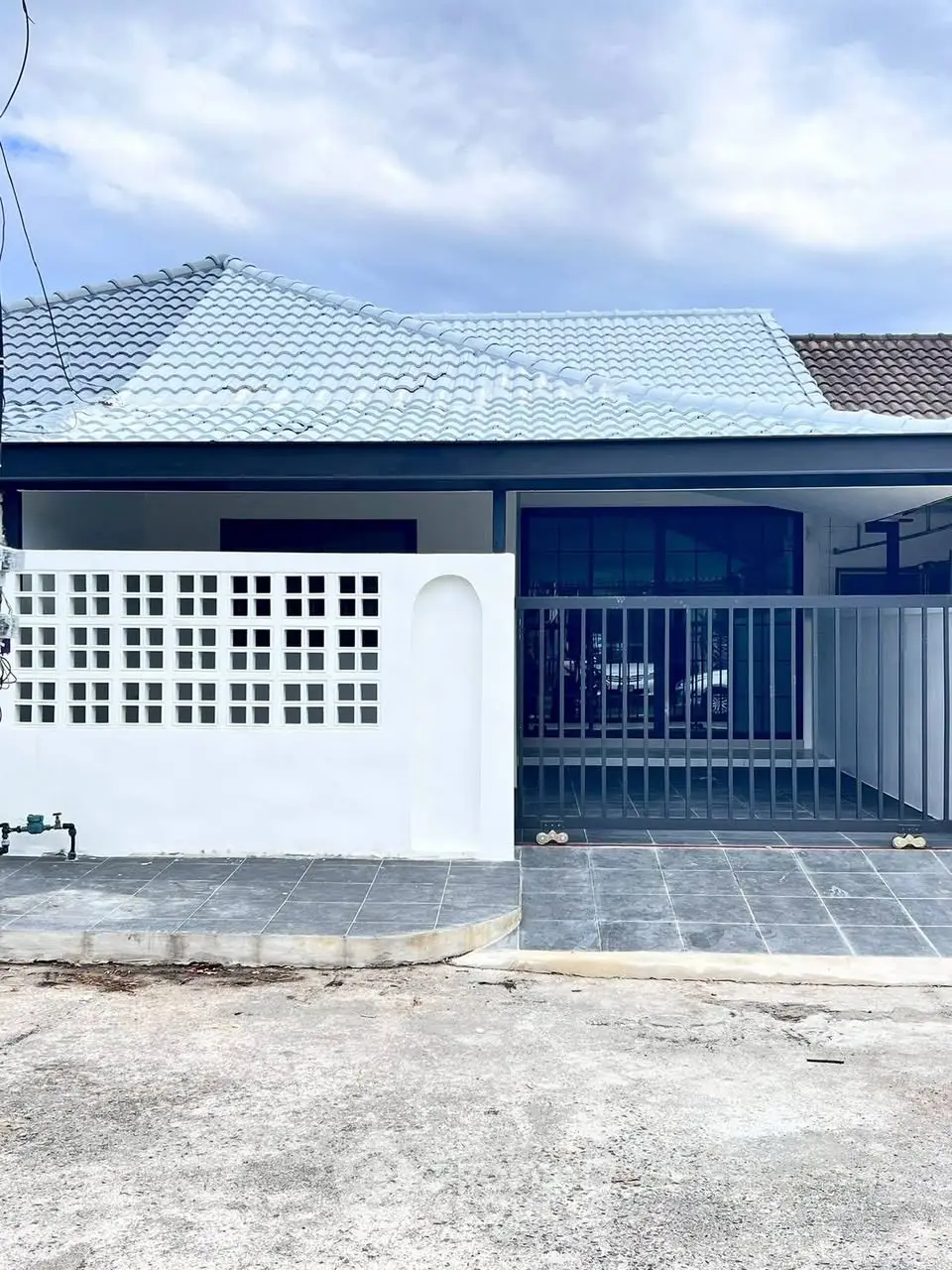 Charming single-story home with modern facade and gated entrance