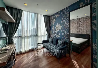 Stylish apartment with modern decor, featuring a cozy living area and a glimpse into a chic bedroom.