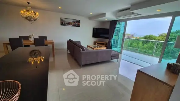Spacious modern living room with open balcony and scenic view, perfect for relaxation and entertaining.