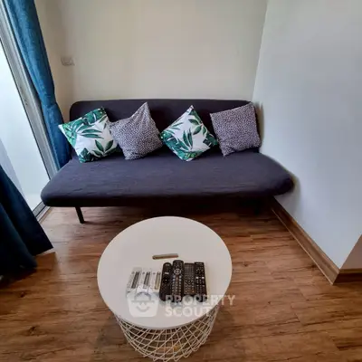 Cozy living room with modern sofa and stylish coffee table, perfect for relaxation.