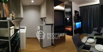 Modern studio apartment with open kitchen, cozy living area, and stylish decor.