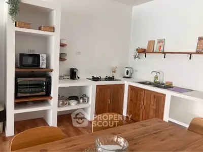 Charming kitchen with wooden cabinets and modern appliances, perfect for culinary enthusiasts.