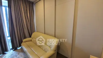 Cozy living room with beige sofa and floor-to-ceiling curtains
