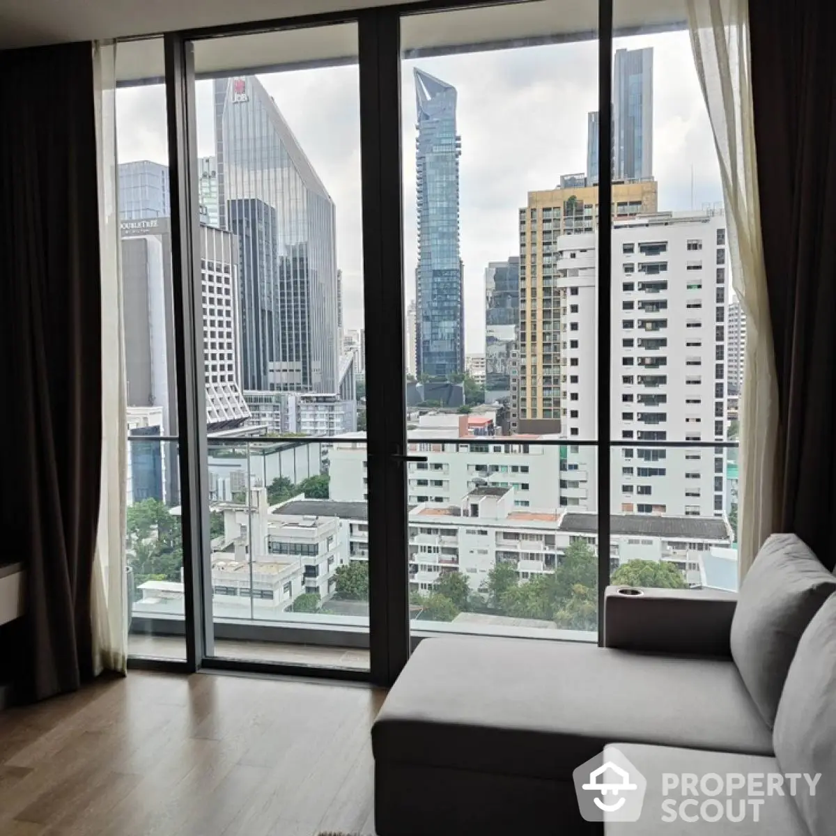 Modern living room with stunning city view from high-rise apartment