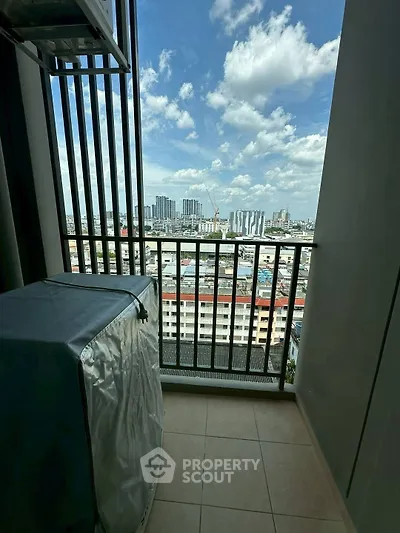 Stunning cityscape view from a modern balcony with protective cover on air conditioning unit.