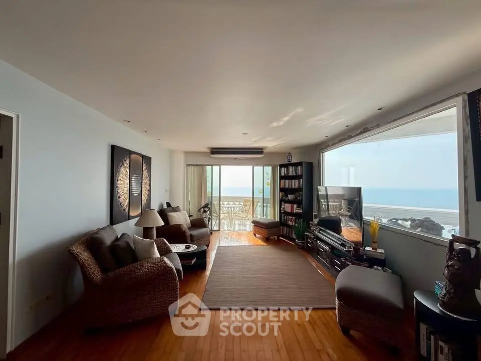 Spacious living room with ocean view and elegant decor, perfect for relaxation and entertainment.