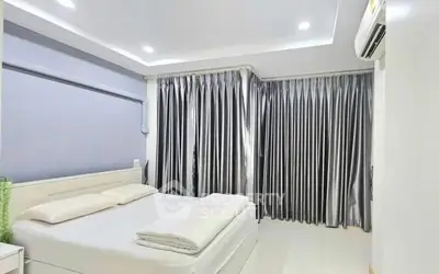 Modern bedroom with sleek design and elegant curtains