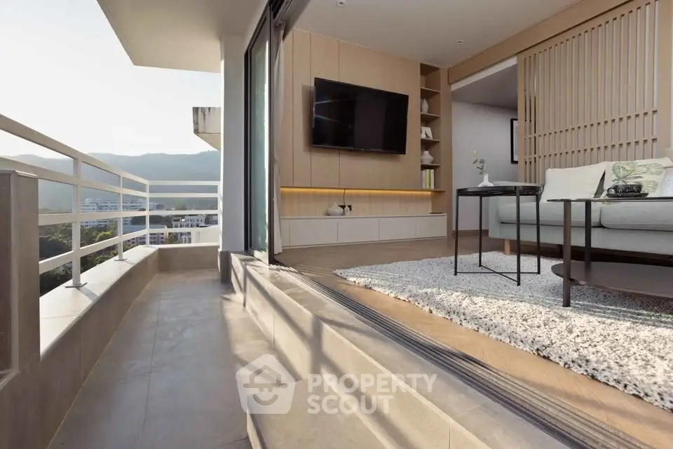 Modern living room with open balcony and scenic mountain view