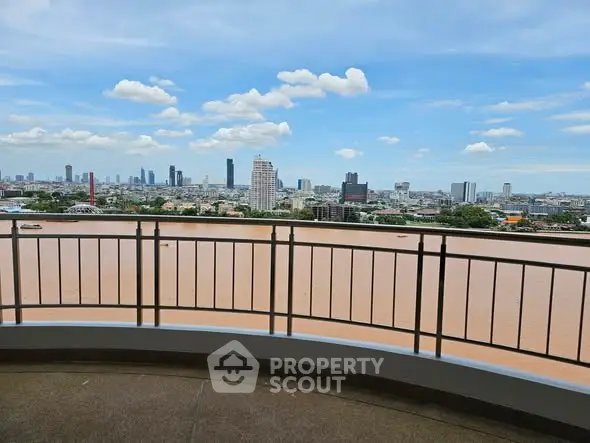 Stunning cityscape view from a high-rise balcony overlooking a river, perfect for urban living enthusiasts.