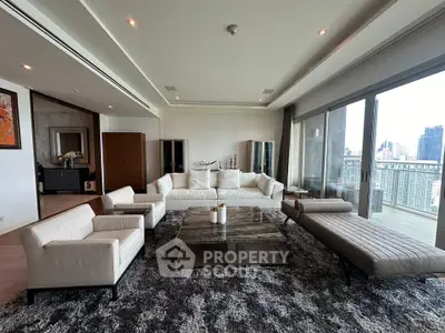 Luxurious living room with panoramic city views and modern furnishings.