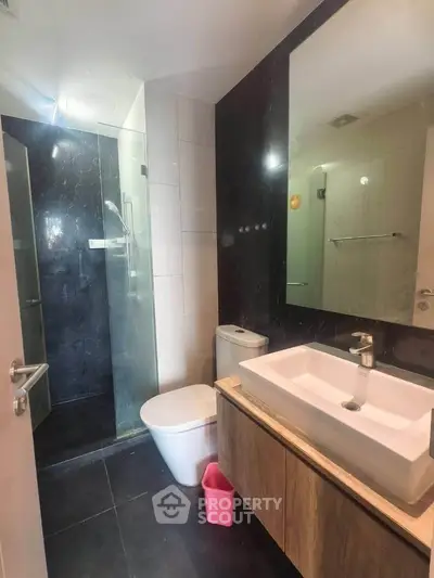 Modern bathroom with sleek fixtures and glass shower enclosure