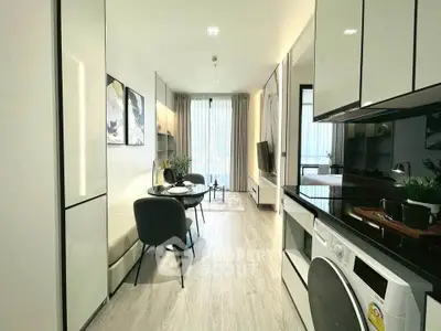 Modern living room with sleek furniture and integrated kitchen appliances in a stylish apartment.