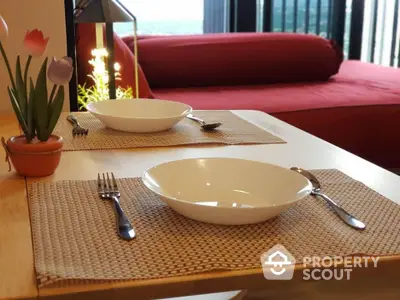 Cozy dining setup with a view, featuring elegant tableware and a comfortable seating area.