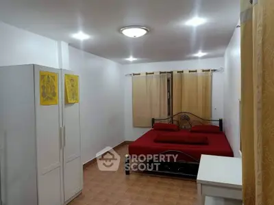 Spacious bedroom with modern decor and ample natural light